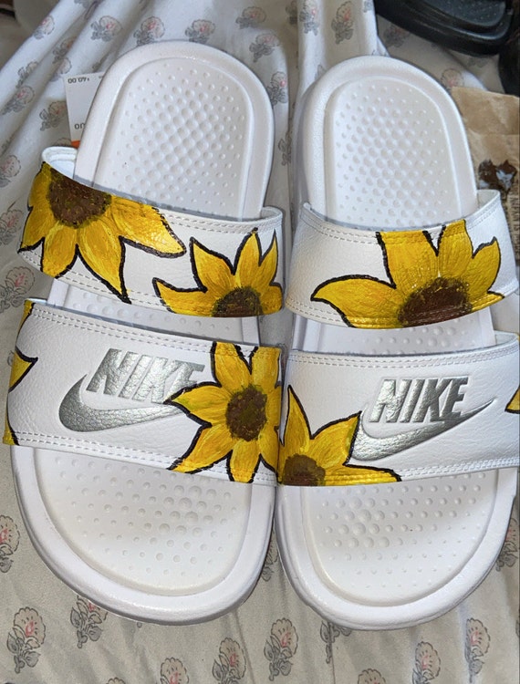 white sunflower nike slides
