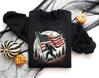 Patriotic Bigfoot T-Shirt – USA Flag Sasquatch Shirt – 4th of July Cryptid Tee – Distressed American Flag Yeti Shirt – Outdoor Camping Shirt