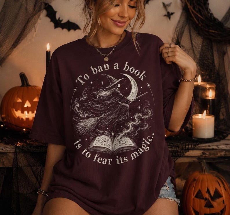 Book lover witch shirt design with vintage Halloween illustration, flying witch, crescent moon, open book and mystical night sky.