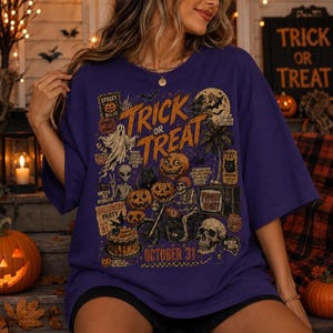 Vintage Halloween graphic t-shirt for women with spooky pumpkins, skeleton biker, ghost, bats and October 31 artwork on a dark green shirt.