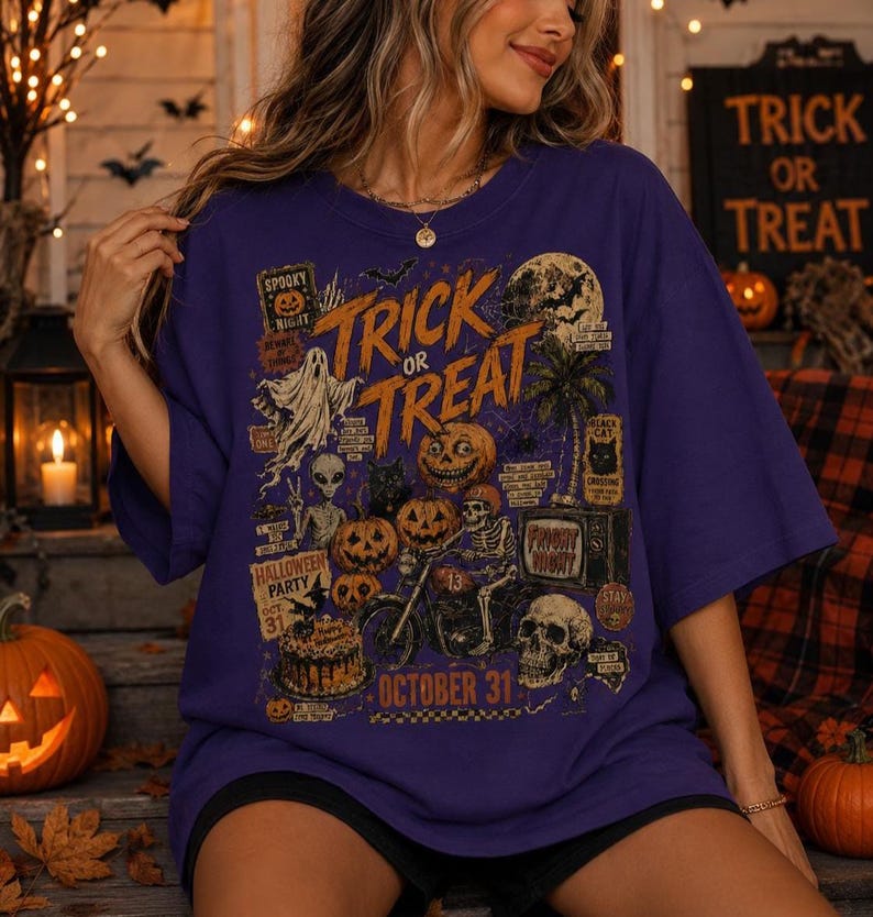 Vintage Halloween graphic t-shirt for women with spooky pumpkins, skeleton biker, ghost, bats and October 31 artwork on a dark green shirt.
