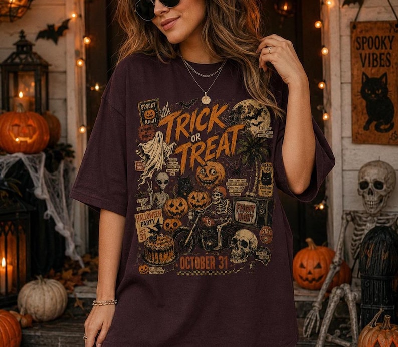 Woman modeling a large Halloween t-shirt with distressed retro Trick or Treat artwork, jack o lanterns, skull, skeleton and spooky night details.
