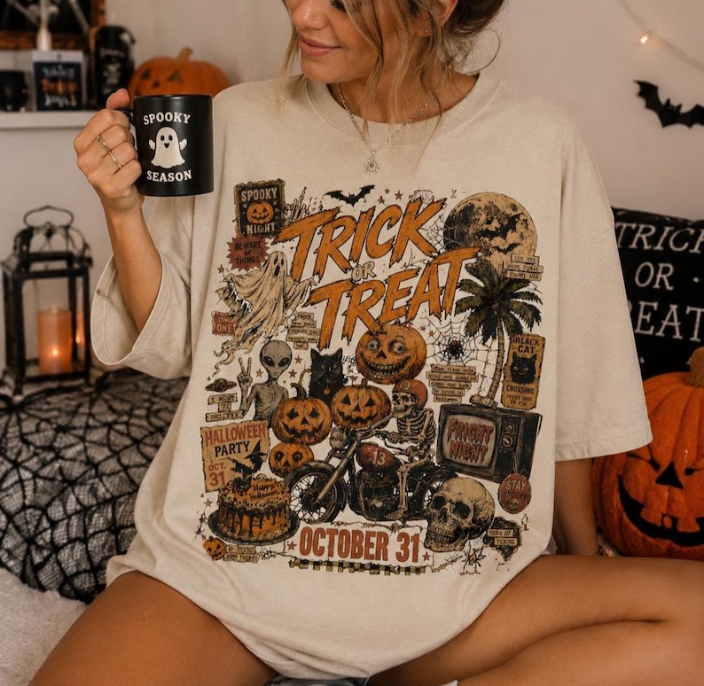 Woman wearing an oversized dark green Halloween t-shirt featuring a vintage Trick or Treat graphic with pumpkins, ghosts, skeletons, bats and October 31 text.