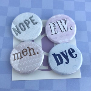 May include: Four round buttons with white backgrounds and various text. The buttons say "NOPE", "EW.", "meh.", and "bye". The buttons are on a white card, set against a light purple checkered background.