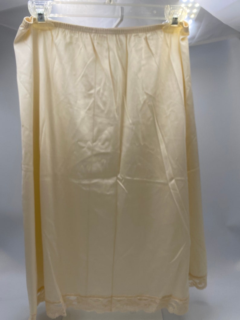 Brand new Vanity Fair Cream Camisole and Half Slip.