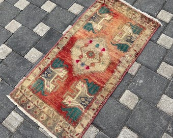 May include: A rectangular area rug featuring a vibrant red field with a central beige medallion and four stylized animal motifs in teal and cream. The rug has a decorative border in shades of brown and beige with white fringe at both ends.