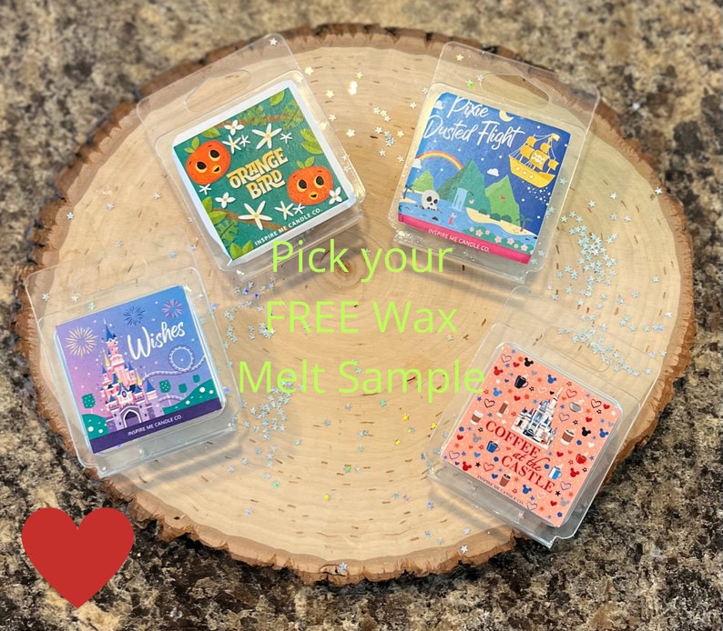 May include: Four wax melt samples displayed on a wooden surface with glitter. The wax melts are in clear plastic packaging and feature different Disney-themed designs. The designs include a castle with fireworks, a coffee cup with a castle, an orange bird, and a pixie dust flight.