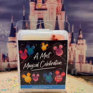 May include: A white wax melt in a clear plastic container with a black label that says "A Most Magical Celebration" with Mickey Mouse ears in balloons. The label also has a 50th anniversary logo with the text "50 years of magic". The label also says "Inspire Me Candle Co."