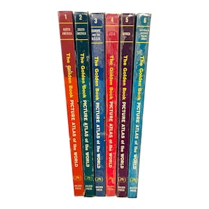 May include: A set of six vintage hardcover books titled The Golden Book Picture Atlas of the World, numbered one through six. The spines are colored red, dark green, blue, bright red, purple, and light blue, featuring yellow text and geographic labels.