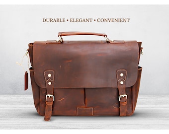 May include: A brown leather briefcase with a top handle and a shoulder strap. The bag has two front pockets with buckles and two brass studs on each side.