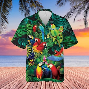 May include: A tropical-themed button-up shirt with a colorful parrot print. The shirt features a variety of parrots in shades of blue, green, red, yellow, and orange, set against a backdrop of lush green leaves.