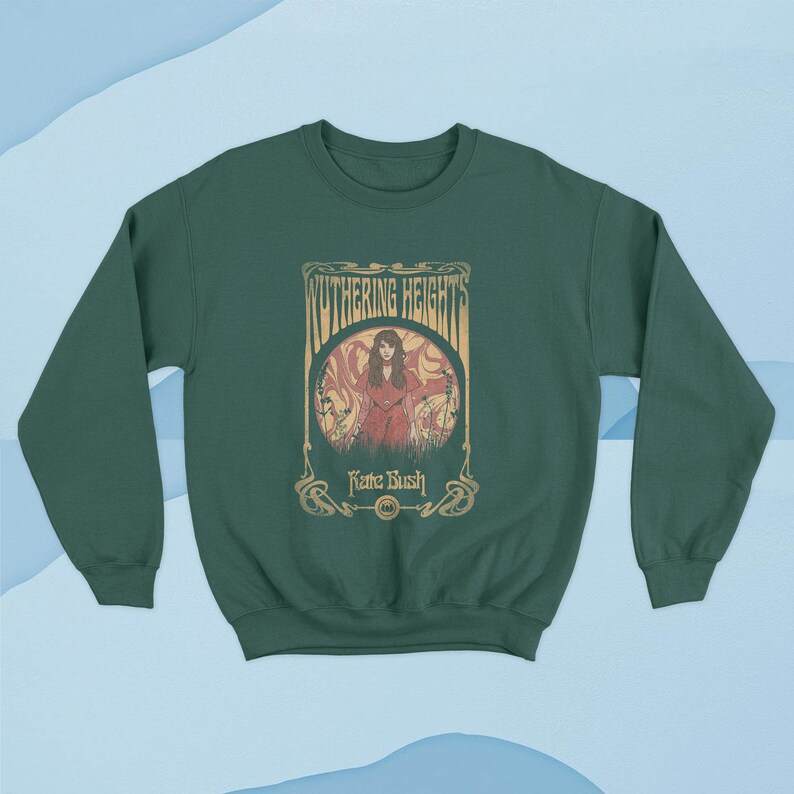 May include: A dark green sweatshirt with a vintage-style graphic of a woman in a red dress standing in a field. The graphic includes the text "Wuthering Heights" and "Kate Bush".