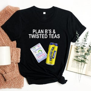 May include: Black t-shirt with white text that reads "PLAN B'S & TWISTED TEAS".  The shirt features a graphic of a Plan B One-Step emergency contraceptive box and a Twisted Tea can.