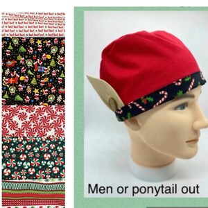 May include: A red elf hat with attached beige ears and a black band with candy cane and holly designs. The hat is displayed on a mannequin head. The image also shows various Christmas-themed fabric patterns.