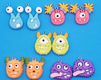 May include: A set of ten colorful monster charms with various expressions. The charms are made of polymer clay and have a hole for attaching to a necklace, bracelet, or keychain.