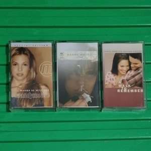 Könnte beinhalten: Drei Kassetten mit unterschiedlichen Covern. Die erste Kassette ist eine Special Edition von Mandy Moores Album "I Wanna Be With You". Die zweite Kassette ist Mandy Moores Album "Mandy Moore". Die dritte Kassette ist der Soundtrack zum Film "A Walk to Remember".