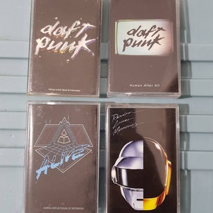 May include: Four cassette tapes featuring the band Daft Punk. The tapes are in clear plastic cases with black labels. The labels feature the band's name and album titles: "Daft Punk", "Human After All", "Alive", and "Random Access Memories".