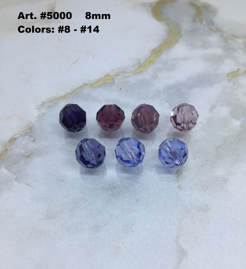 May include: Six 8mm round glass beads in various shades of purple and blue. Art. #5000 Colors: #8 - #14