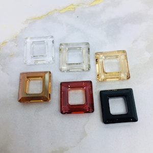 May include: Six square-shaped glass embellishments with a hole in the center. The embellishments are in various colors, including clear, light brown, dark brown, red, and black.