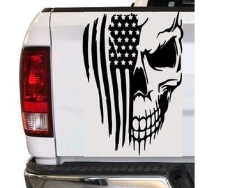 May include: Black and white decal of a skull with an American flag behind it. The decal is applied to the back of a white pickup truck.