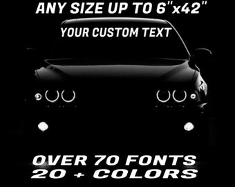 May include: A black car with headlights on, with the text "ANY SIZE UP TO 6"x42" YOUR CUSTOM TEXT OVER 70 FONTS 20+ COLORS" in white lettering.