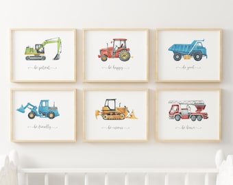 May include: Six framed prints with watercolor illustrations of construction vehicles and inspirational messages. The prints feature a green excavator, a red tractor, a blue dump truck, a blue backhoe, a yellow bulldozer, and a red fire truck. Each print has a different message, such as "be patient", "be happy", "be good", "be friendly", "be curious", and "be brave".