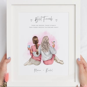 May include: A white framed print with a pink watercolor background featuring two women with long hair sitting back to back. The text reads "Best Friends" with the quote "There are friends, there is family. Then there's friends that became family." The names Monica and Rachel are written below the image.