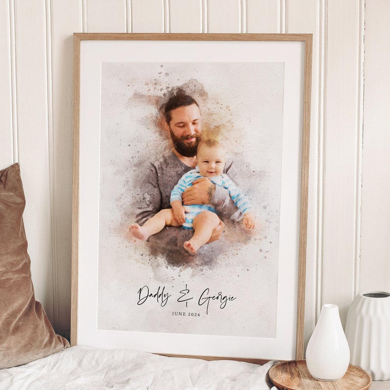 May include: A watercolor print of a father and son. The father is holding the son in his arms. The text "Daddy & Georgie" and "JUNE 2024" is below the image.