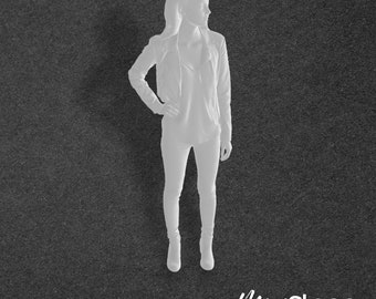 Abigail - Scale Model Box Unpainted Figure of Woman wearing leggings, leather jacket and boots she stands with he right hand on her hip.