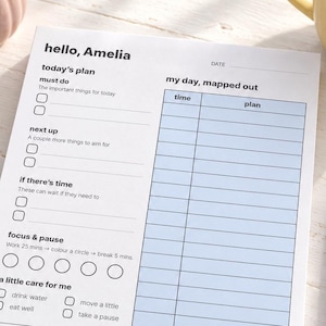 May include: A white daily planner sheet titled hello, Amelia with sections for today's plan, must do, next up, if there's time, focus & pause, a little care for me, brain dump, and a light blue columned schedule for my day, mapped out.