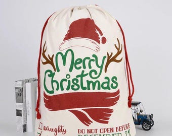 May include: A white canvas Santa sack with red and green trim. It has a red Santa hat with a white band and the words "Merry Christmas" in green letters. The sack has a red drawstring and the words "Do Not Open Before December 25" printed on the bottom.