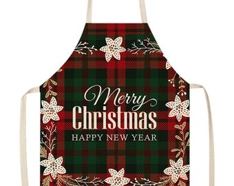 May include: Red and green plaid Christmas apron with a white floral wreath and the text "Merry Christmas Happy New Year".