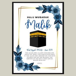May include: A white card with a gold frame and blue floral accents. The card has the text "Hajj Mubarak Malik" and a black and gold image of the Kaaba. The text "Dhul Hijjah 1445 AH - June 2024" is below the image. The card also includes a message wishing someone a happy Hajj.