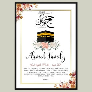 May include: A white card with gold trim and floral accents. The card features an illustration of the Kaaba, a mosque in Mecca, Saudi Arabia. The text on the card reads "Hajj Mubarak" in Arabic and "Ahmed Family" in English. The card also includes the date "Dhul Hijjah 1445 AH - June 2024" and a message wishing the family a blessed Hajj.