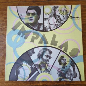 May include: A yellow, blue, and pink record album cover with the word "IMPALA" in large black letters. The cover features four musicians in circular frames. The album is titled "Impala" and is a Usana Music Co. release.