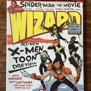 May include: A Wizard magazine cover featuring a red and yellow logo with the text "Wizard" in white. The cover features a cartoon illustration of the X-Men characters Wolverine, Cyclops, Rogue, and Jean Grey. The cover also features a smaller image of Tobey Maguire as Spider-Man from the movie Spider-Man. The cover text includes "All-New X-Men Toon Preview", "New Member, New Costumes", "What the-?! Winners of the Annual Halloween Costume Contest", "Price Guides, Graded Comics, Original Art and More!" and "Online Comics 50 Must-See Web Sites".