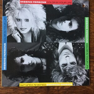 May include: A black and white photo collage of four people, each with a different hairstyle and expression. The text "MISSING PERSONS COLOR IN YOUR LIFE" is repeated four times around the border of the image.