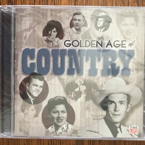 May include: A CD case with a collage of country music stars from the Golden Age of Country. The title "Golden Age of Country" is printed in large, bold letters. The case is black with a clear plastic front.