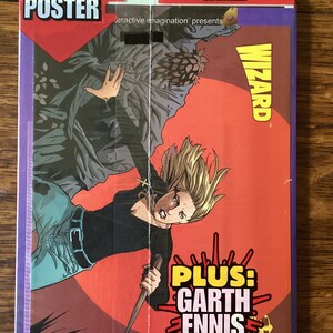 May include: A red and yellow comic book cover featuring a woman with blonde hair holding a knife. The cover text reads "FREE BUFFY POSTER" and "PLUS: GARTH ENNIS CHECKLIST".