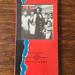 May include: A CD case with a red and black design. The front features a black and white photo of a group of men and the text "BUS BOYS". The text "MONEY DON'T MAKE NO MAN" is also visible. The case is sealed in plastic.