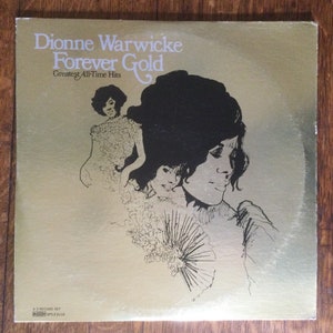 May include: A gold record album cover with a black and white illustration of Dionne Warwick. The album title is "Forever Gold: Greatest All-Time Hits".