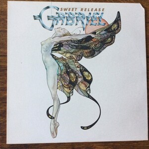 May include: A white vinyl record album cover with a blue and white graphic of a woman with butterfly wings. The album title "SWEET RELEASE" and the artist name "GABRIEL" are printed in blue and white text.