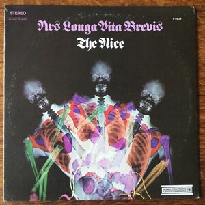 May include: A black and white album cover with a psychedelic image of three skeletons in a colorful, abstract design. The album title is "Ars Longa Vita Brevis" by "The Nice".