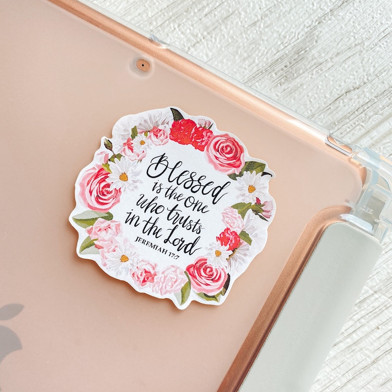 May include: A white sticker with a floral wreath border and the text "Blessed is the one who trusts in the Lord Jeremiah 17:7".