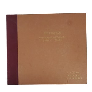 May include: A brown cardboard box with a maroon spine. The box has gold lettering that reads "BEETHOVEN Quartet No. 10, in E Flat Major ('Harp') (Op. 74)" and "A VICTOR MUSICAL MASTERPIECE".