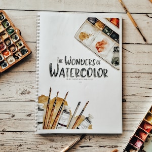 May include: A watercolour art book titled "The Wonders of Watercolour: An Art Guide for Beginners and Enthusiasts" with a watercolour illustration of paint tubes, brushes, and a paint palette on the cover.