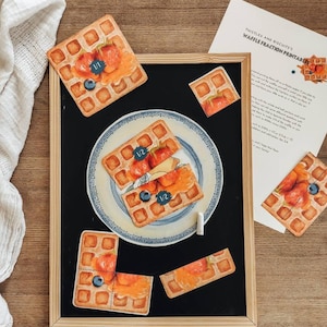 May include: A set of waffle fraction printable cards. The cards feature a waffle with different toppings, including strawberries, blueberries, and syrup. The cards are labeled with fractions, such as 1/2 and 1/4. The cards are designed to help children learn about fractions.