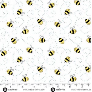 May include: White fabric with a repeating pattern of cartoon bees in yellow and black, with small blue dots and curved lines. The bees have smiling faces and are surrounded by dotted trails. The fabric is marked with a ruler along the bottom.