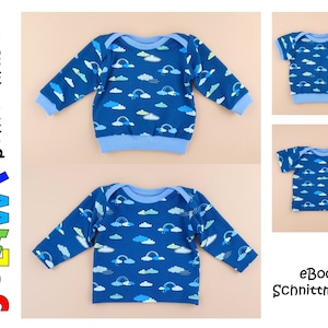 Könnte beinhalten: Zwei blaue und weiße Baby-Shirts mit einem Regenbogen- und Wolkenmuster. Das Langarmshirt hat einen blauen gerippten Halsausschnitt und Bündchen. Das Kurzarm-Shirt hat einen blauen gerippten Halsausschnitt. Beide Shirts haben den Text "eBook Schnittmuster" unten rechts.