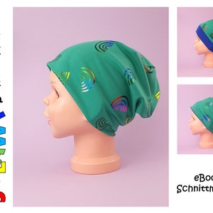 Puede incluir: Un gorro verde con un patrón de arcoíris. El gorro está hecho de un tejido suave y elástico y tiene un ajuste holgado. El gorro se muestra en una cabeza de maniquí.